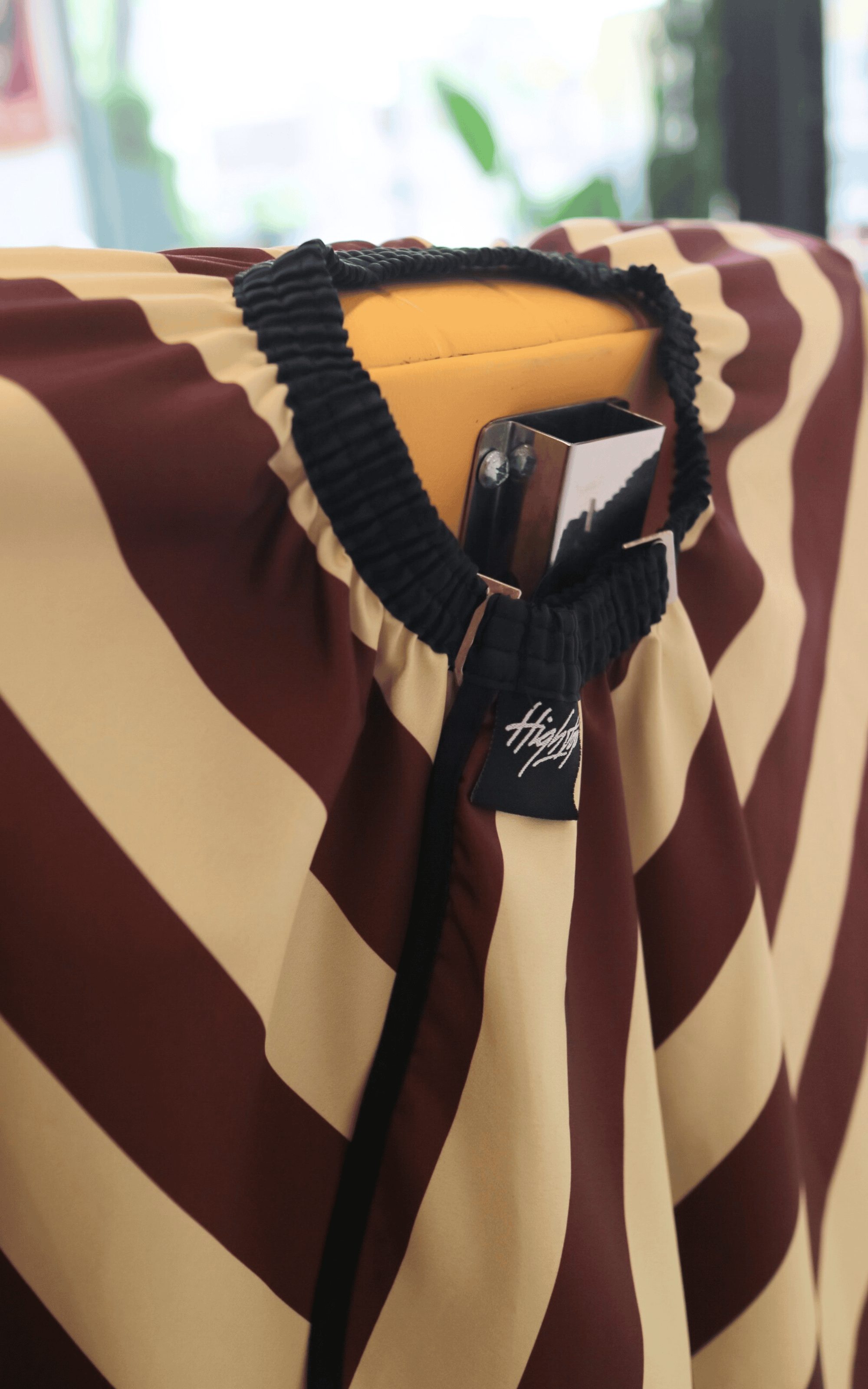 photo of elastic neck on burgundy banded barber cape