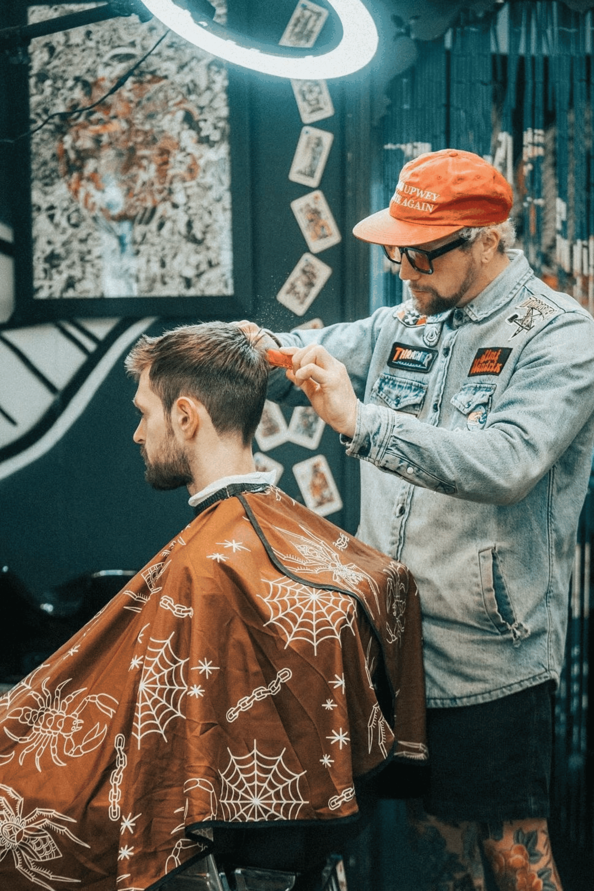 barber in funky barbershop cutting customers hair using the Outback Copper Cape