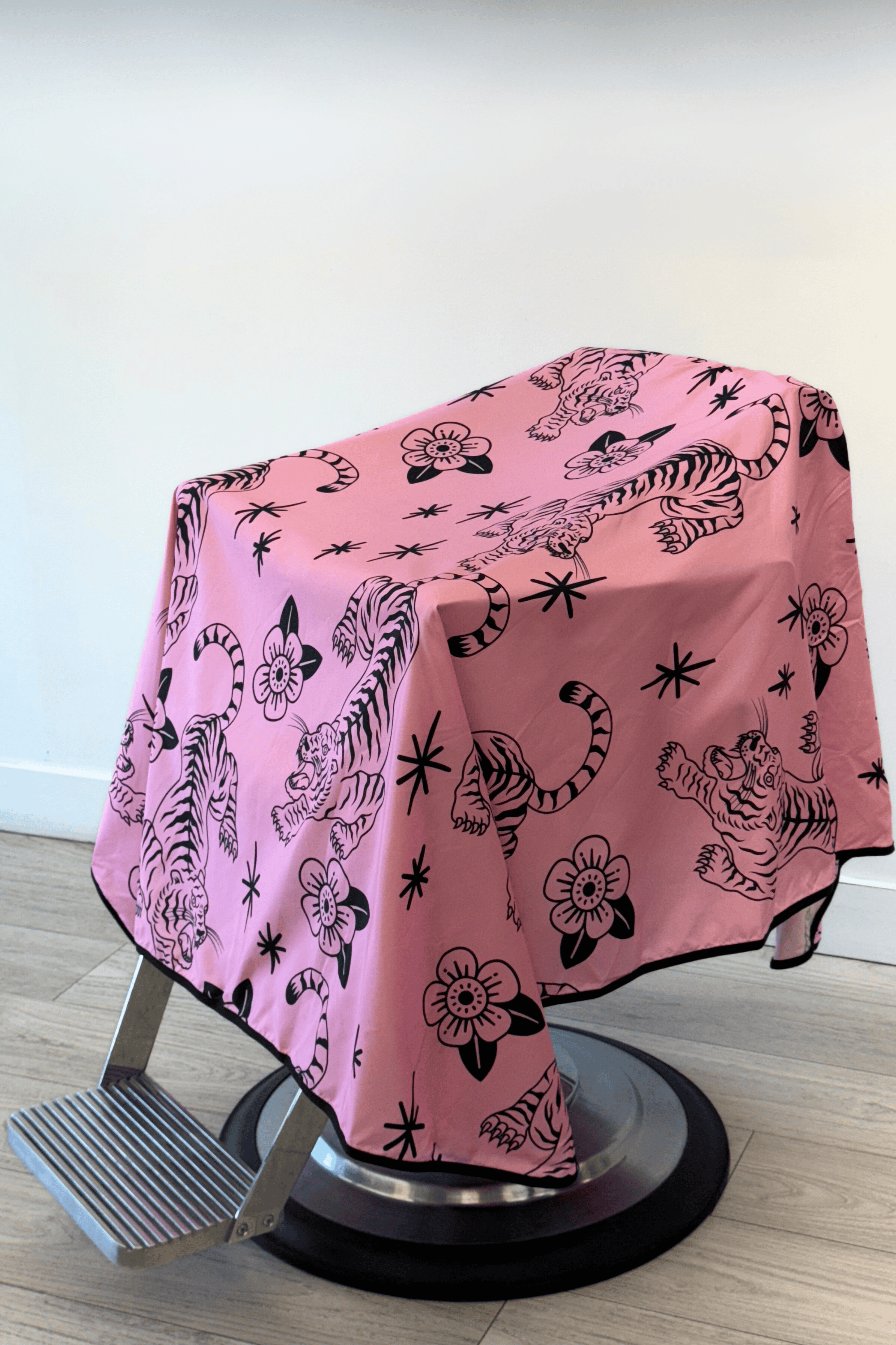 pink and black barber cape with crawling tigers and flowers