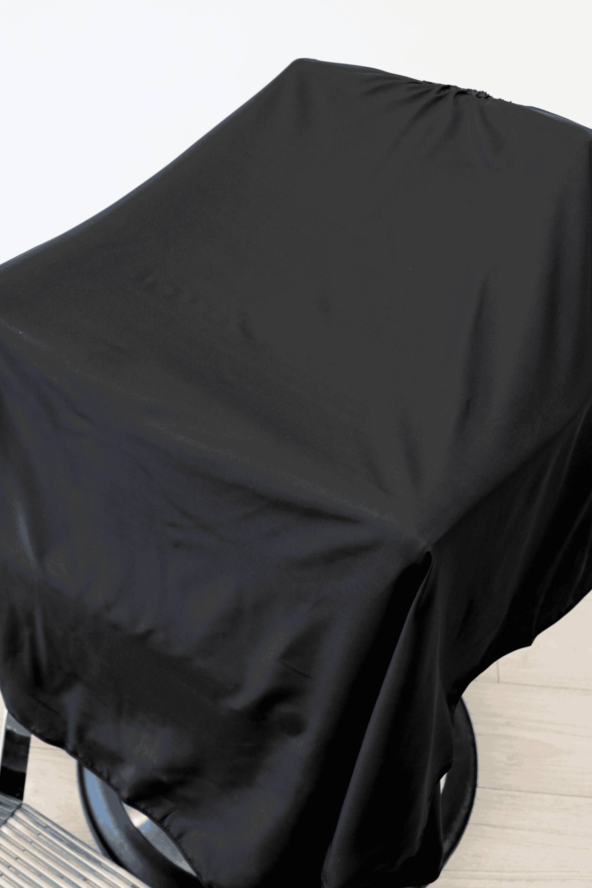 close up of the plain barber cape draped on barbershop chair