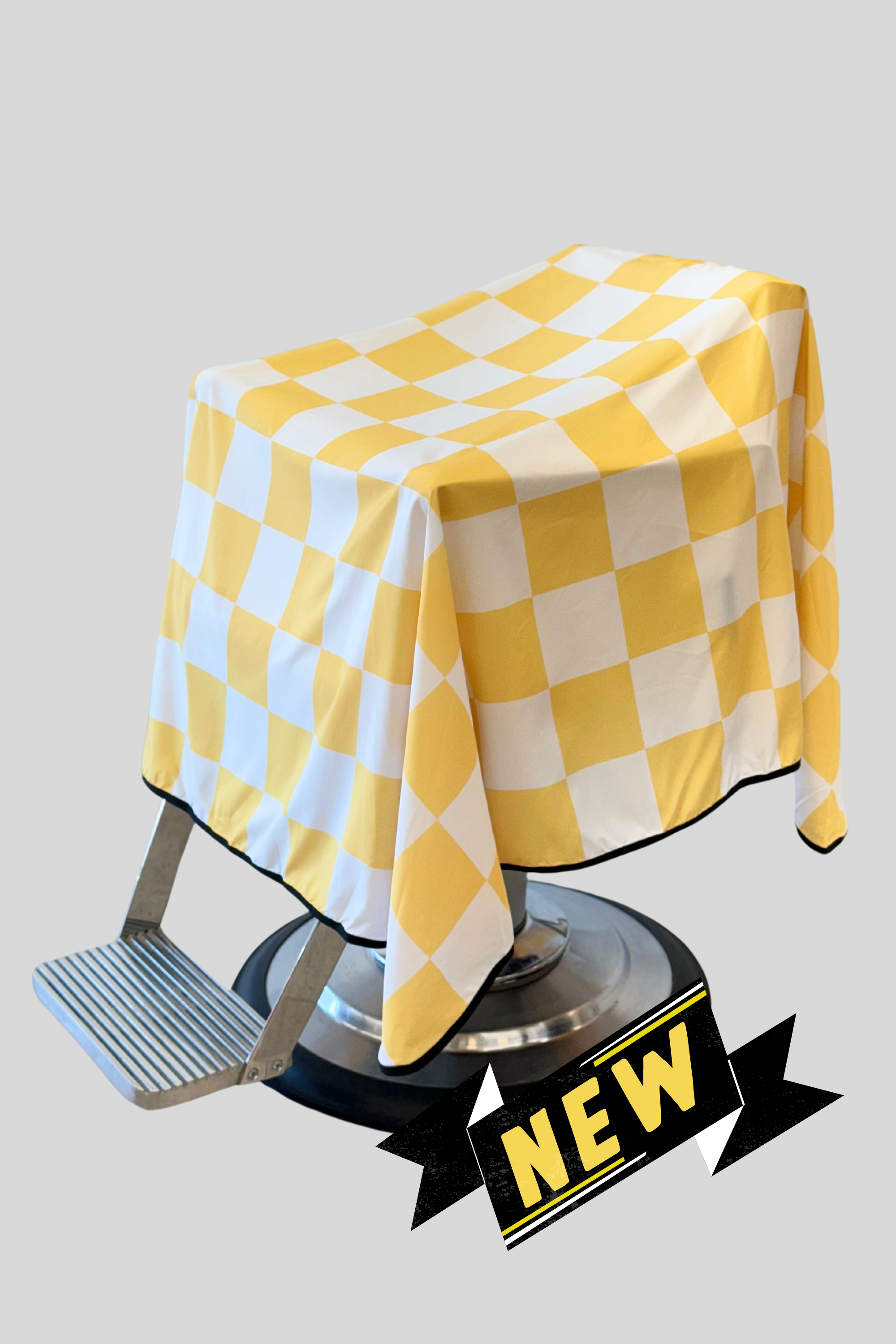 main product photo of the yellow and white rally v2 barber cutting cape with "NEW" banner